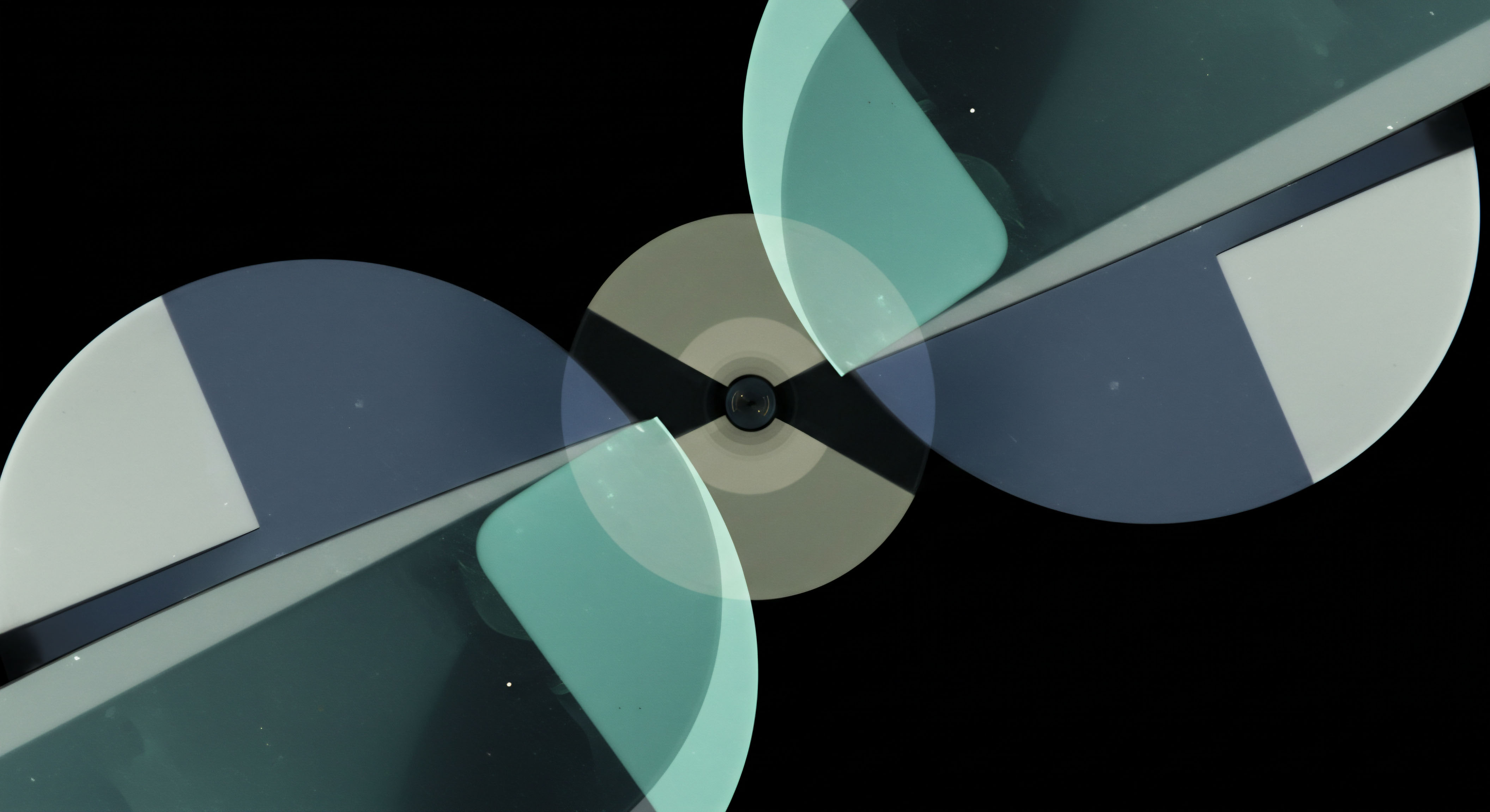 Overlapping semi-transparent geometric planes in muted teal blue and slate gray emanate from a central hub suggesting rotational dynamics or cyclical market phases. This formation abstracts the intricate entanglement of synthetic positions within decentralized finance DeFi collateral pools. The visual effect mimics the continuous adjustment required for maintaining tight delta-neutral exposure across multi-leg perpetual swaps or complex option vault strategies requiring precise rebalancing. Centralized convergence implies execution locus for atomic settlement or oracle price feeds impacting leveraged yield farming mechanisms. The ethereal glow hints at latent volatility embedded in underlying asset distribution influencing premium decay and intrinsic value calculations for exotic digital asset derivatives.