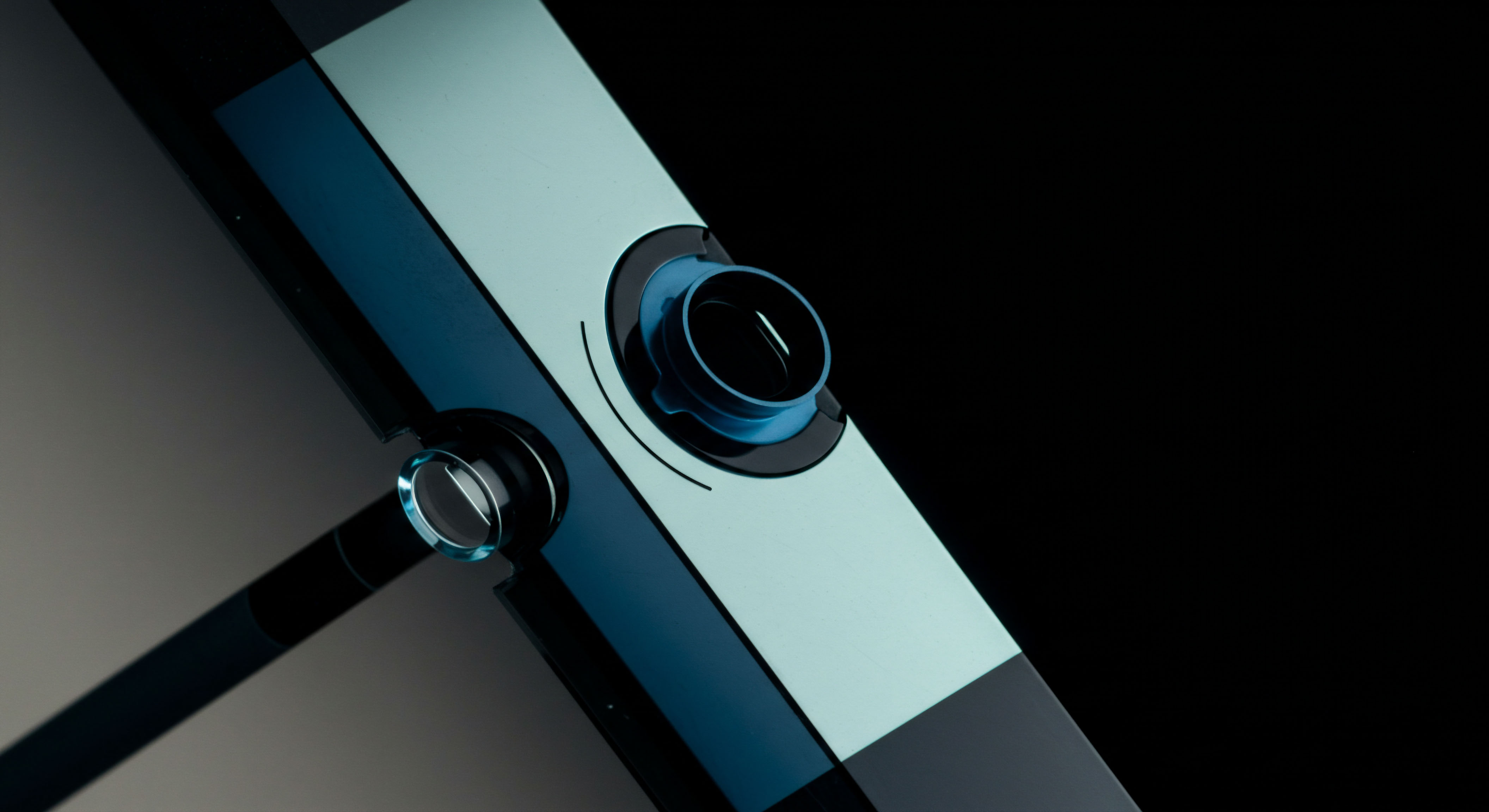 This macro photograph captures polished surfaces with stark color contrast, suggesting precision engineering inherent in complex financial instruments. The illuminated circular apertures resemble access ports or key components within a high-frequency trading architecture or a permissioned distributed ledger technology interface. The interplay of cool cyan blue and deep matte black evokes themes of cryptographic security and cold storage mechanisms vital for securing on-chain assets. This visual metaphor represents the intricate interconnection required for successful automated market making collateralization and the robust execution of perpetual futures contracts requiring reliable oracle price feeds for delta hedging strategies. Effective governance token staking necessitates such secure infrastructural integrity for stable yield farming operations.