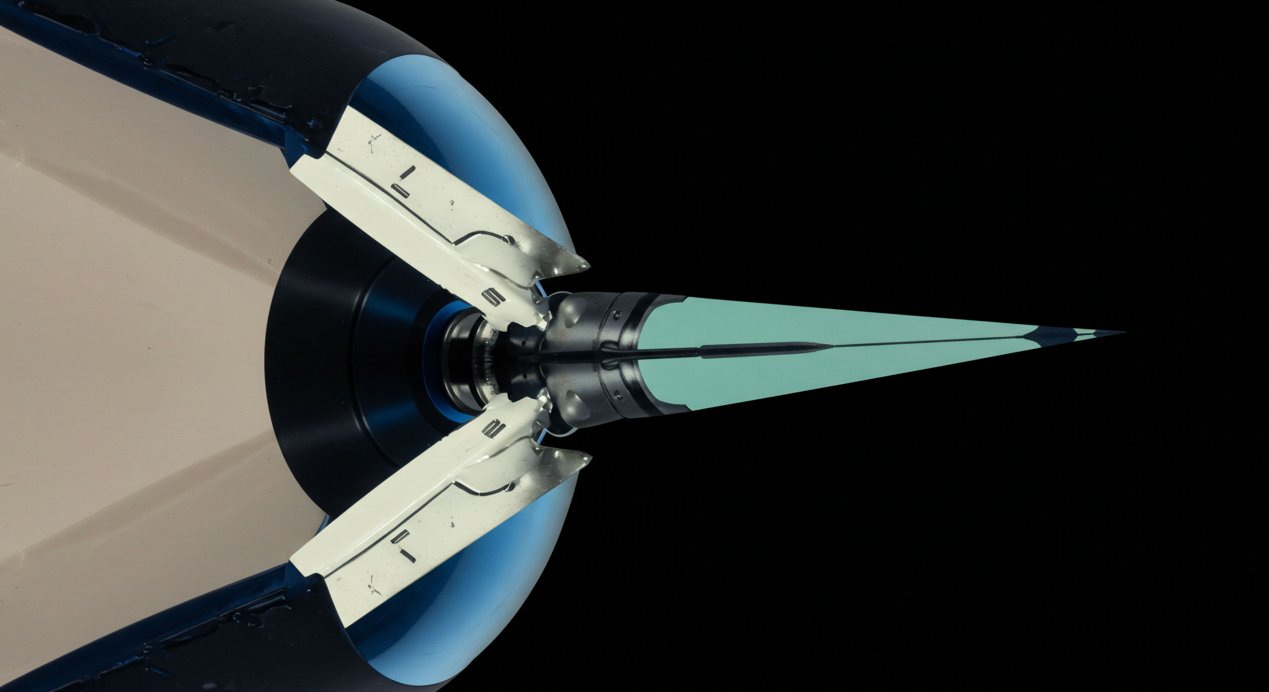 The image reveals a sharp, pale cyan, elongated structure, reminiscent of an advanced dart or nosecone, symmetrically mounted within a complex mechanical housing featuring off-white actuators against dark blue and black chassis elements, suggesting forward momentum. This configuration embodies the concept of a market microstructure probe executing sub-second arbitrage across decentralized exchanges. The piercing geometry symbolizes aggressive directional bets in exotic derivatives such as volatility swaps or variance futures settled in digital assets. The precise alignment suggests optimized execution parameters for dark pool liquidity sourcing within DeFi protocols, minimizing slippage for large-scale token swaps or synthetic asset repositioning. This architecture reflects sophisticated order flow telemetry crucial for competitive yield farming strategies and managing complex basis risk inherent in perpetual futures markets.