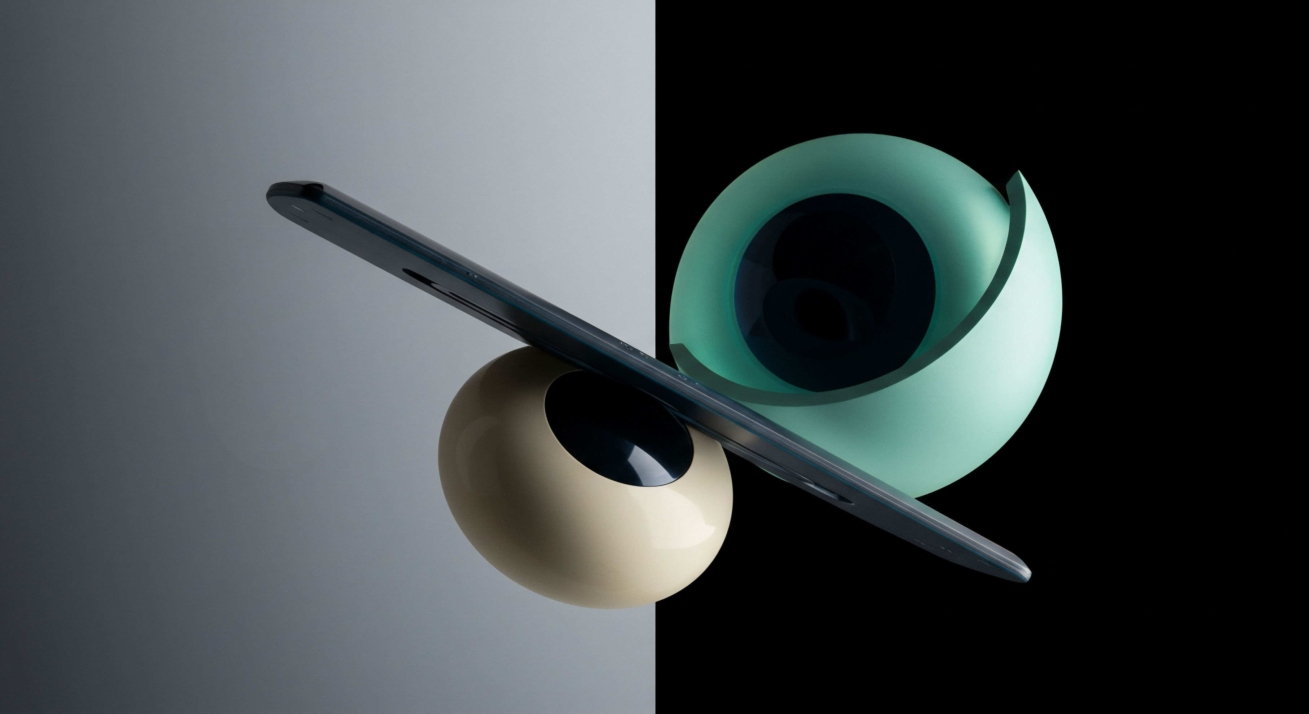 This composition features a slender, dark metallic object juxtaposed over two smooth, ovate structures, bifurcating a background gradient from light gray to absolute black. The oblique orientation suggests dynamic equilibrium under duress, mirroring the delicate balancing act inherent in structuring complex crypto options mandates. The pale beige sphere anchors the lighter side representing measured collateralization or perhaps stablecoin parity, while the teal, partially unfolded torus on the dark side signifies extreme market excursions or implied volatility skew. This abstract visualization encapsulates the constant management of delta hedging against parabolic price discovery in decentralized finance perpetual futures markets, emphasizing the requirement for precise execution against underlying asset price action dynamics like slippage mitigation and premium decay assessment.