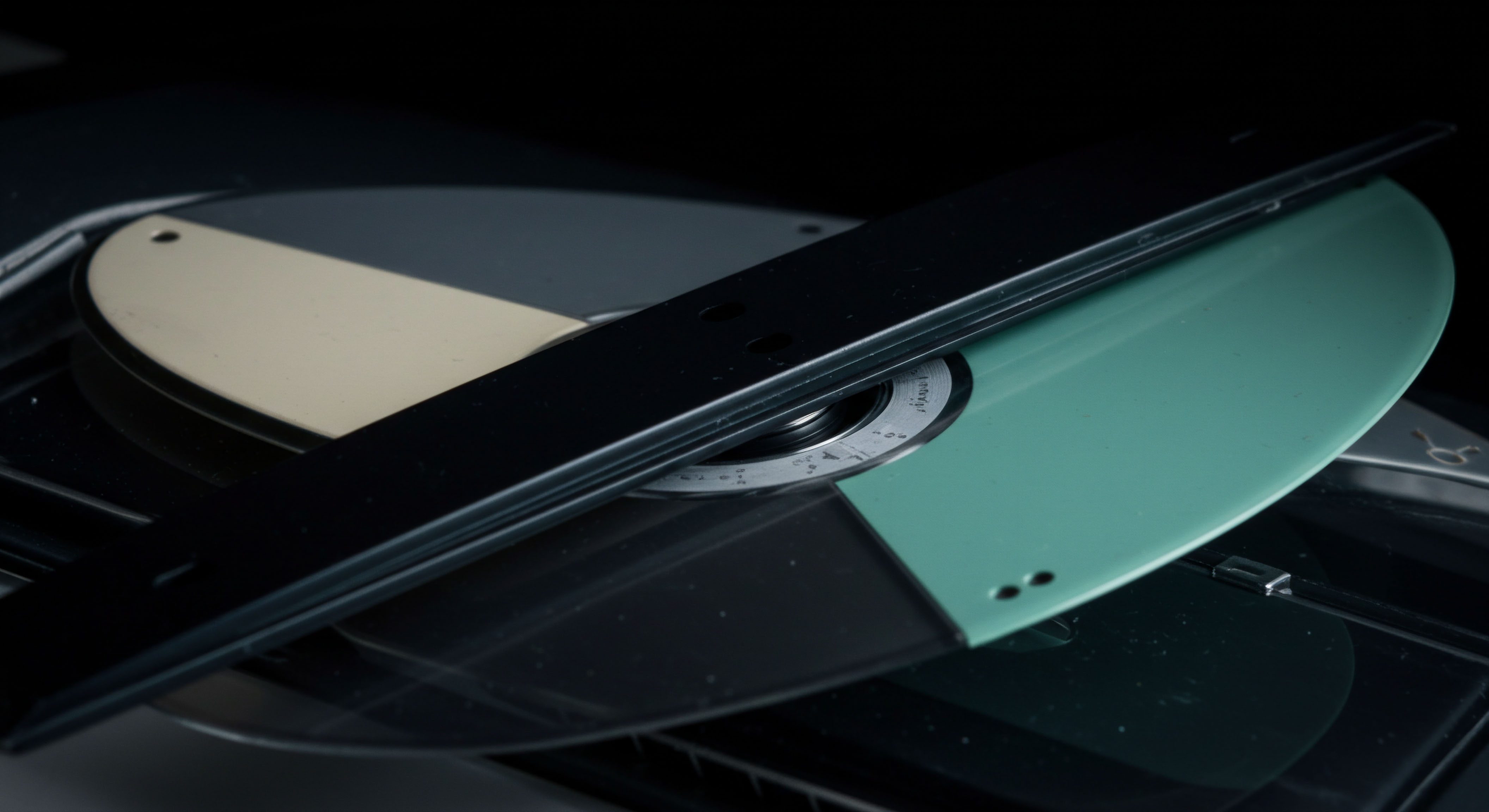 The image reveals a precision calibration tool, resembling a rotational spectrophotometer target or an analog data reference, juxtaposed against dark machinery, suggesting rigorous pre-trade validation protocols. This setup metaphorically illustrates the complex calibration required for pricing exotic options on decentralized finance platforms. The segmented fields of muted beige, deep black, and soft teal evoke spectral analysis essential for determining true value in high-frequency cryptocurrency derivatives markets. Effective risk modeling necessitates precise initialization, mirroring the analog fidelity suggested by the measurement markings near the center hub. This visual anchors concepts like implied volatility skew, stochastic processes in asset price discovery, and the stringent need for oracles providing immutable real-world inputs for smart contract execution concerning perpetual futures hedging.