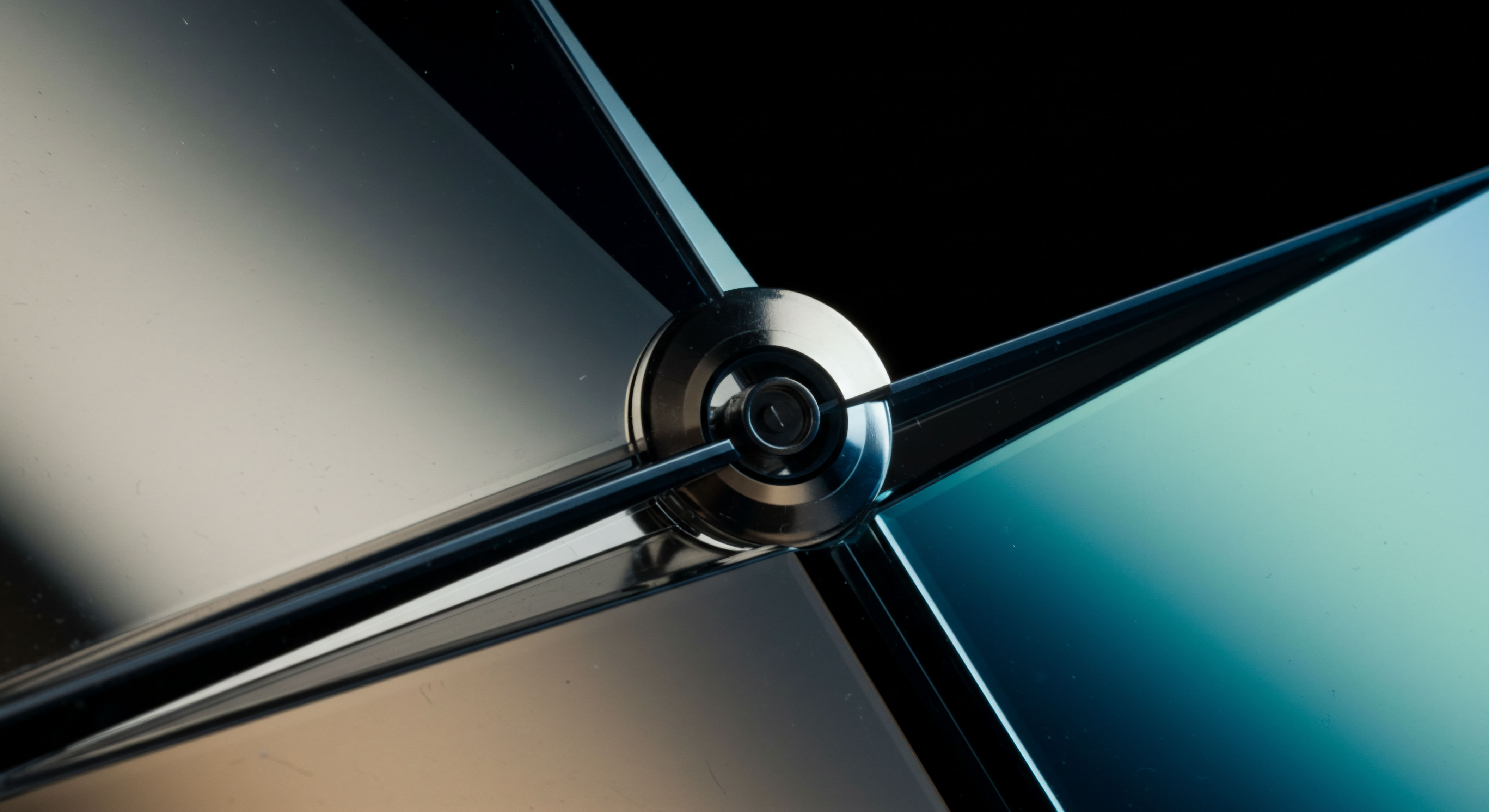 Metallic central pivot point symbolizes the convergence of liquidity pools and derivative contract resolution. Four reflective facets exhibit dramatic spectral shifts from pale beige to deep cyan illustrating portfolio beta exposure across bifurcated markets. This macro structure mirrors the structural integrity required for secure decentralized exchange settlement layers. The intersecting planes evoke complex option payoff diagrams especially concerning long straddles or short condors where volatility skew dictates terminal asset value. Precision engineering suggests the reliability necessary for automated market maker algorithms executing high frequency arbitrage across DeFi yield farming platforms. Analyzing these reflections reveals underlying system stress points indicative of potential margin calls or liquidation cascades in leveraged synthetic asset trading.