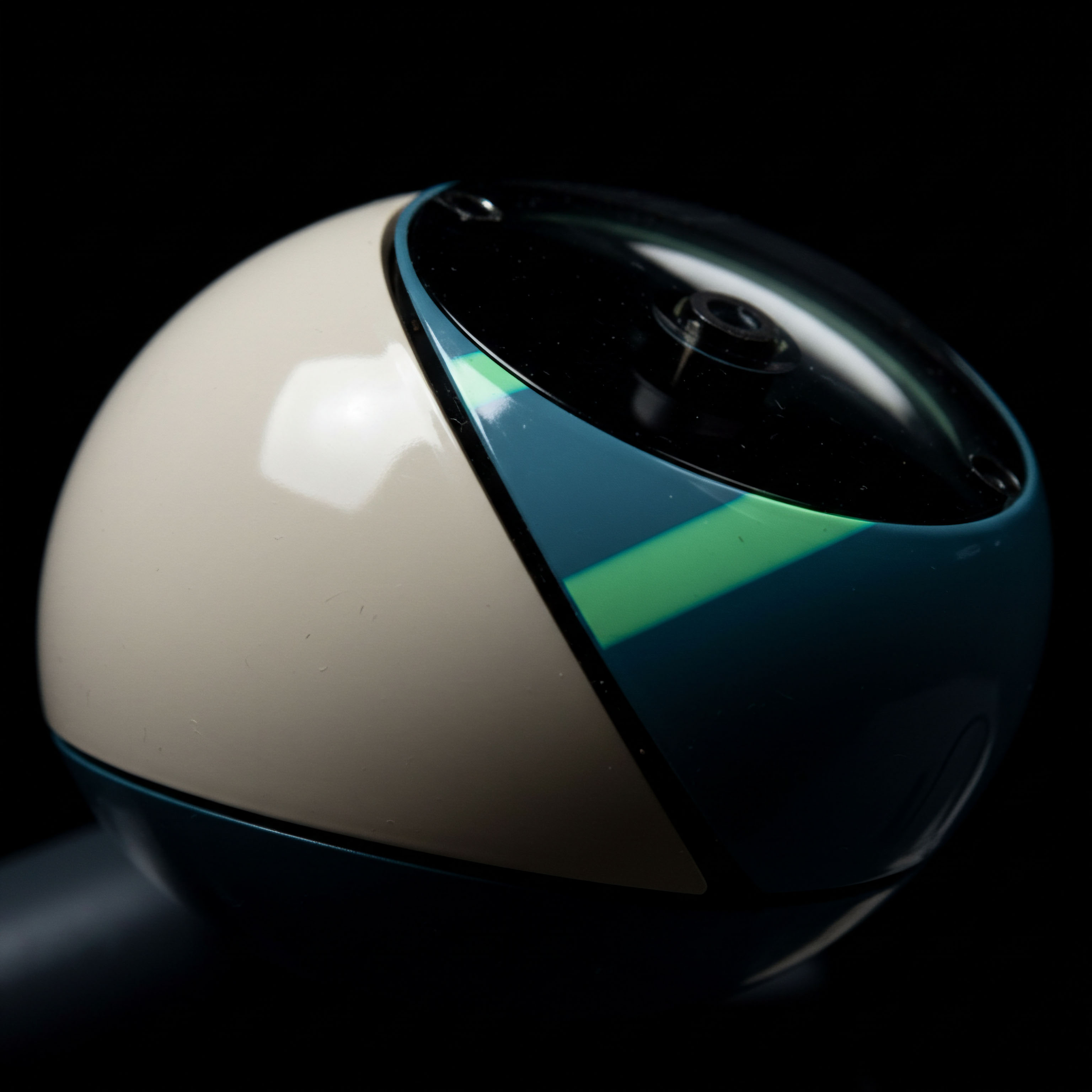 This highly polished, spherical structure, divided starkly between matte beige and deep teal sections accentuated by a vibrant lime green diagonal vector, symbolizes the intricate geometry of volatility surfaces in perpetual futures contracts. The smooth, reflective lens housing suggests opaque order book depth and potential arbitrage gaps inherent in high-frequency DeFi operations. The contrasting segments represent bifurcated market narratives, perhaps contrasting spot market absorption against systemic risk inherent in leveraged yield farming protocols. The inherent spherical nature evokes continuous price discovery mechanisms and non-linear payout profiles characteristic of exotic options valuation frameworks within decentralized autonomous organizations DAOs executing complex structured products like synthetic collateralized debt positions CDOs. The focused lighting emphasizes the materiality of trustless execution environments.