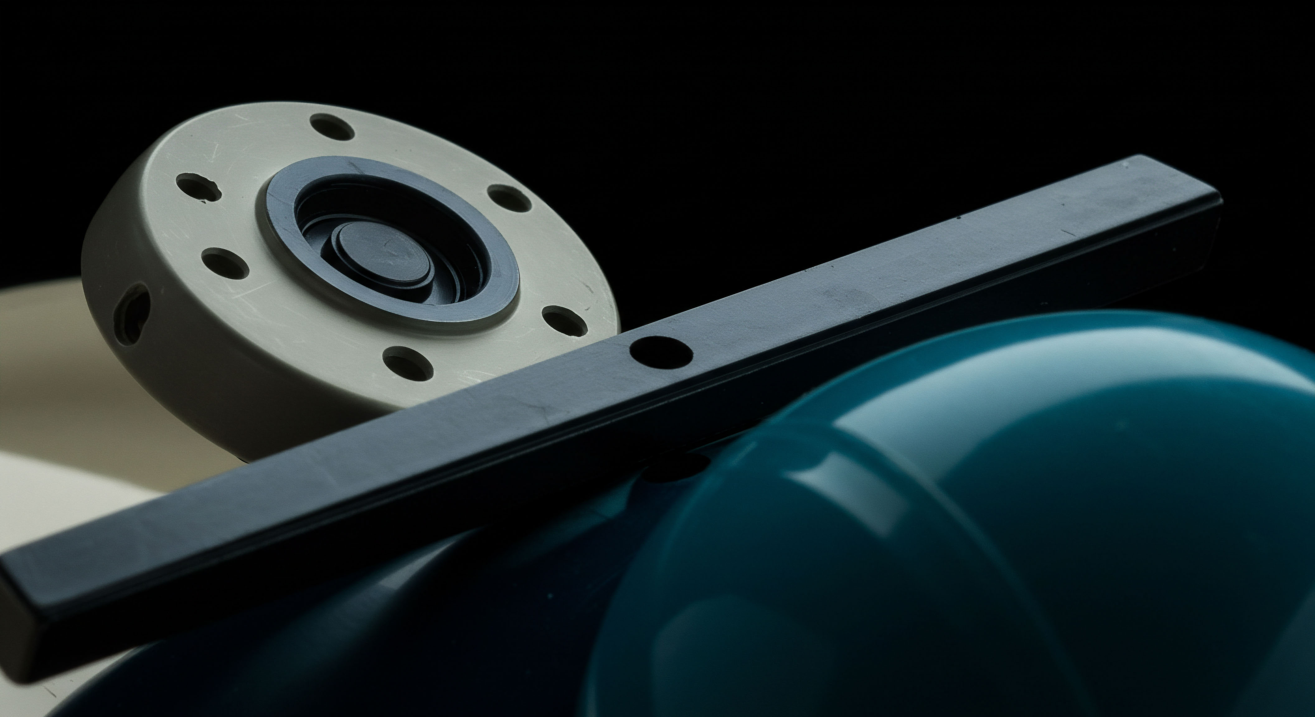 This composition features industrial components suggesting engineered precision, mirroring the structured mechanics of decentralized finance protocols. The pale, perforated flange element implies a governance token structure or perhaps a collateralized debt position component, while the rigid black bar represents a clear execution path or a delta-hedging mechanism across the volatility surface. The dominant, glossy cyan sphere evokes the concept of liquid staking derivatives or perhaps a deep liquidity pool undergoing continuous rebalancing. This juxtaposition visualizes the complex interplay between automated market maker impermanent loss and optimized yield farming strategies essential for DeFi robustness against sharp price discovery events impacting synthetic asset valuations.