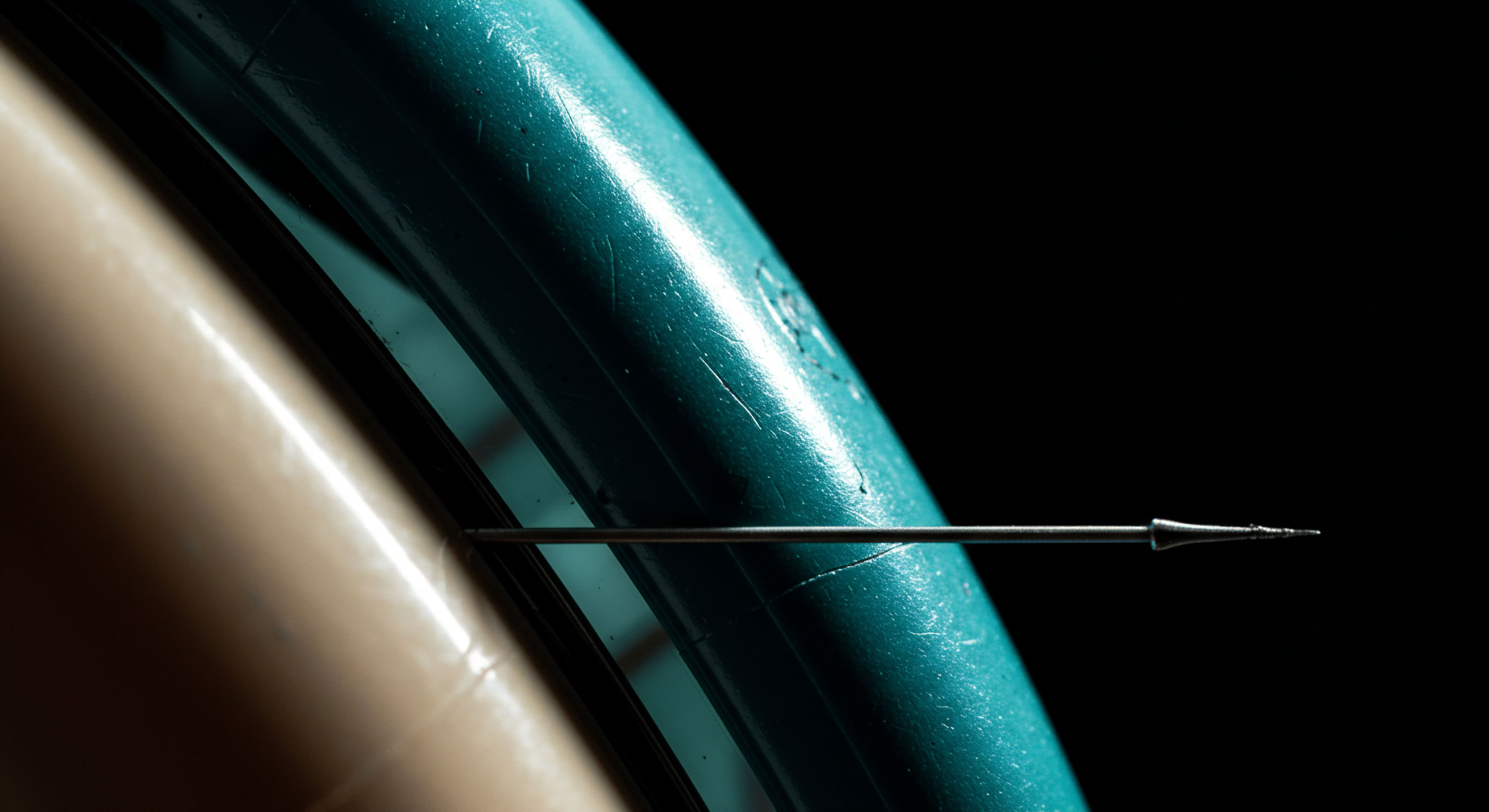 This macro view depicts a fine metallic stylus piercing a textured cyan substrate adjacent to a smooth, pale ochre surface, metaphorically representing critical junctures in decentralized finance execution. The needle tip symbolizes the precision required for atomic unit trades during volatile market microstructure phases. This scenario mirrors the piercing of resistance or support levels in options delta hedging strategies executed against immutable smart contracts. The stark lighting emphasizes the sharp transition between the solidified liquidity structure and the aggressive penetration, suggesting low latency transaction finality, crucial for minimizing slippage in decentralized exchange order books. Terms like collateralization requirements, implied volatility skew, and gamma exposure are invoked by this visual tension between structure and invasive execution.