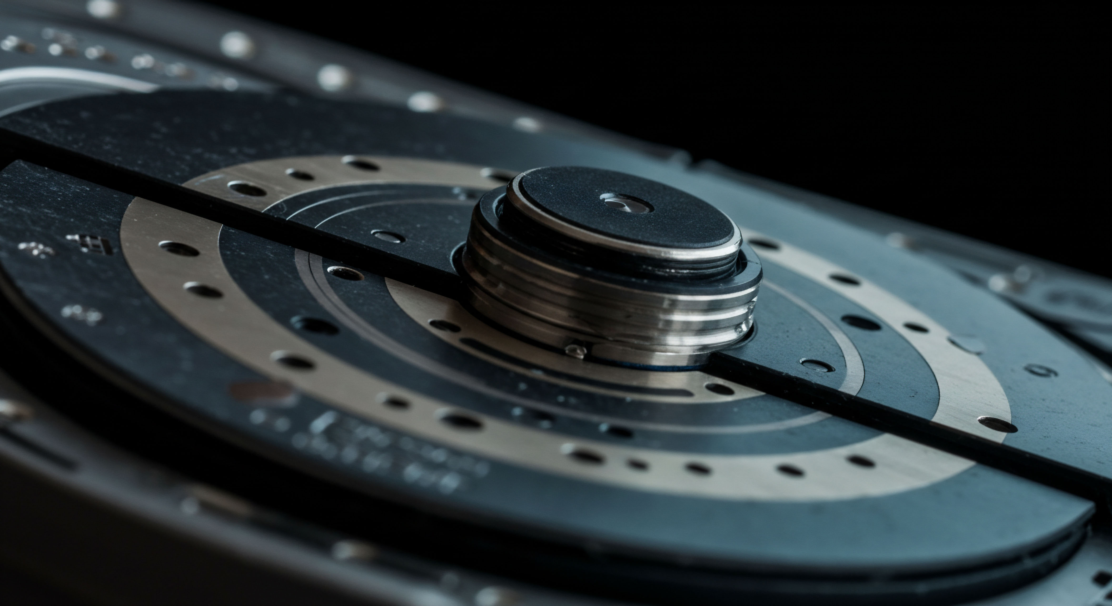 The close-up reveals precision-machined metallic layers and a central spindle suggesting immutable data structures foundational to blockchain ledger persistence. Concentric rings and small apertures evoke synchronized block propagation and the critical timing inherent in decentralized finance DeFi derivatives pricing models. This visual metaphor represents the mechanical latency juxtaposed against instantaneous digital settlement required for optimized limit order book execution and efficient atomic swaps utilizing sophisticated layer two scaling solutions. The dark, high-contrast environment emphasizes the high-stakes nature of on-chain governance voting requiring robust security protocols against reentrancy attacks and oracle manipulation within complex synthetic asset protocols.