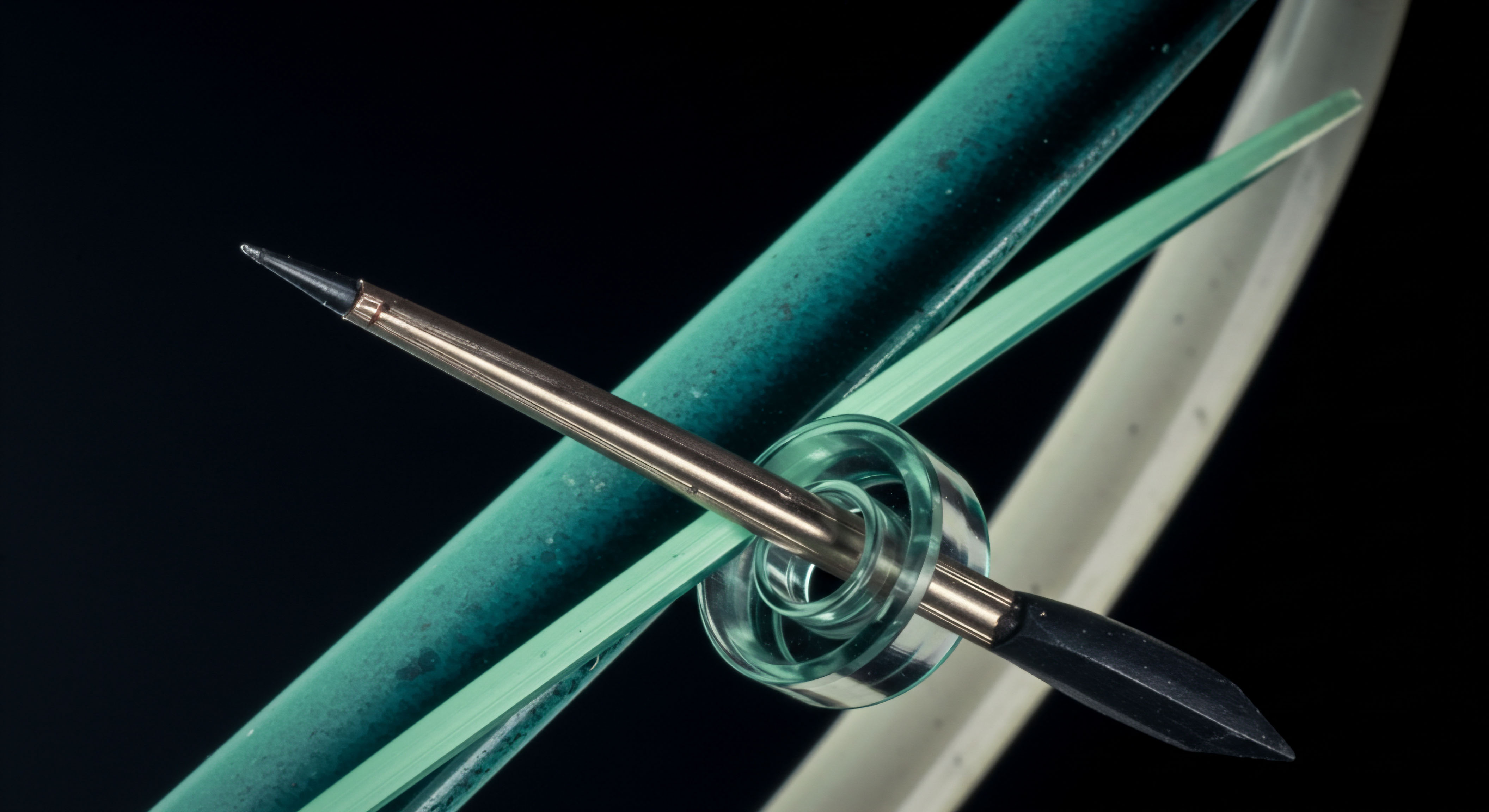 This extreme close-up showcases a metallic, pointed stylus passing centrally through a translucent, layered, helix-like bearing, set against contrasting textured cyan tubing and a pale curved backdrop. Conceptually, it models the precise execution of a Block-Settlement mechanism or a complex Collateralized Debt Position rollover within decentralized finance DeFi protocols. The focused intersection represents a critical point of transaction finality or the crossing of the strike price barrier in an exotic derivative structure like a Barrier Option. The components suggest the delicate balance required for effective Limit Order execution, illustrating the friction within cross-chain asset transfer mechanisms or the physical representation of an atomic swap utilizing smart contract logic. This visual metaphor underscores the high-stakes precision necessary for managing volatile crypto asset exposures and navigating order book depth in nascent derivatives markets.