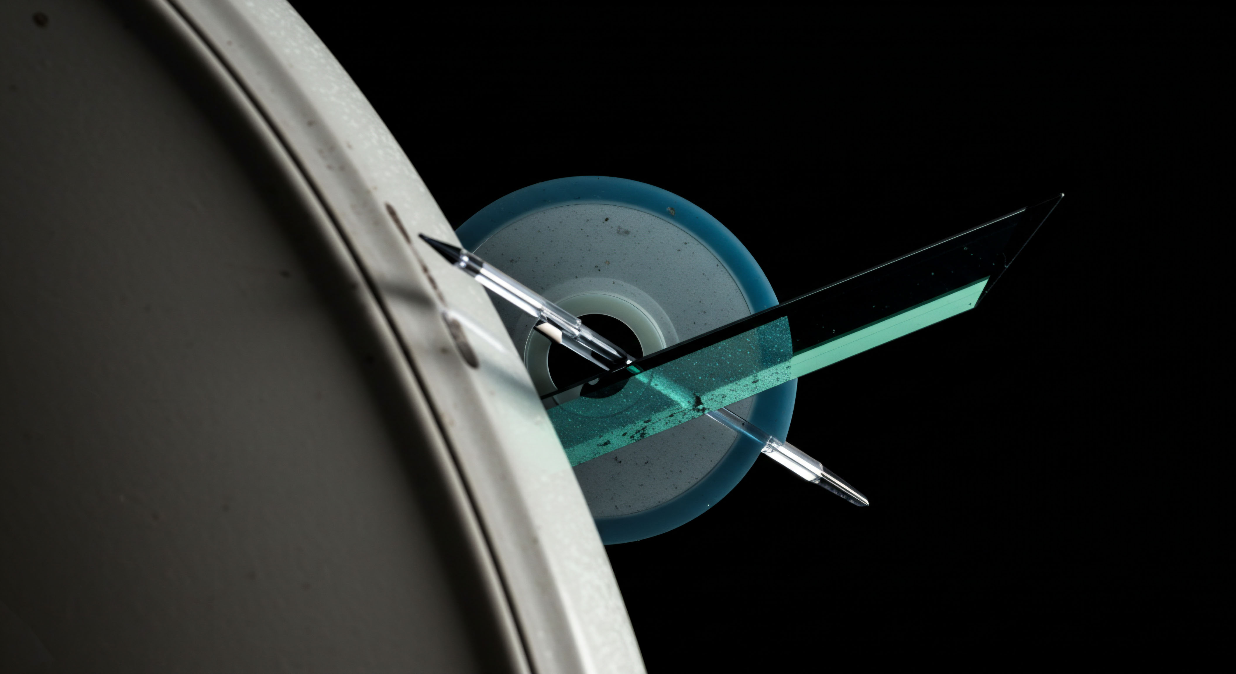 This abstract, high-contrast composition illustrates the kinetic energy transfer reminiscent of executing complex derivatives within DeFi protocols. A metallic stylus, symbolizing execution speed or a market maker's bid-ask precision, pierces a translucent, cyan-hued planar object, suggesting a tokenized asset or a digital collateralized position. The surrounding opaque, curved structure evokes the enclosure of a legacy system or a centralized exchange gateway being bypassed by innovative financial instruments. This visual metaphor captures the moment of strike price realization within options trading against volatile crypto asset underlyings. Concepts like implied volatility surface geometry and perpetual contract settlement mechanics are implied by the intersecting vectors of light and structure, emphasizing the leverage inherent in on-chain structured products and achieving instantaneous price discovery across various trading venues.