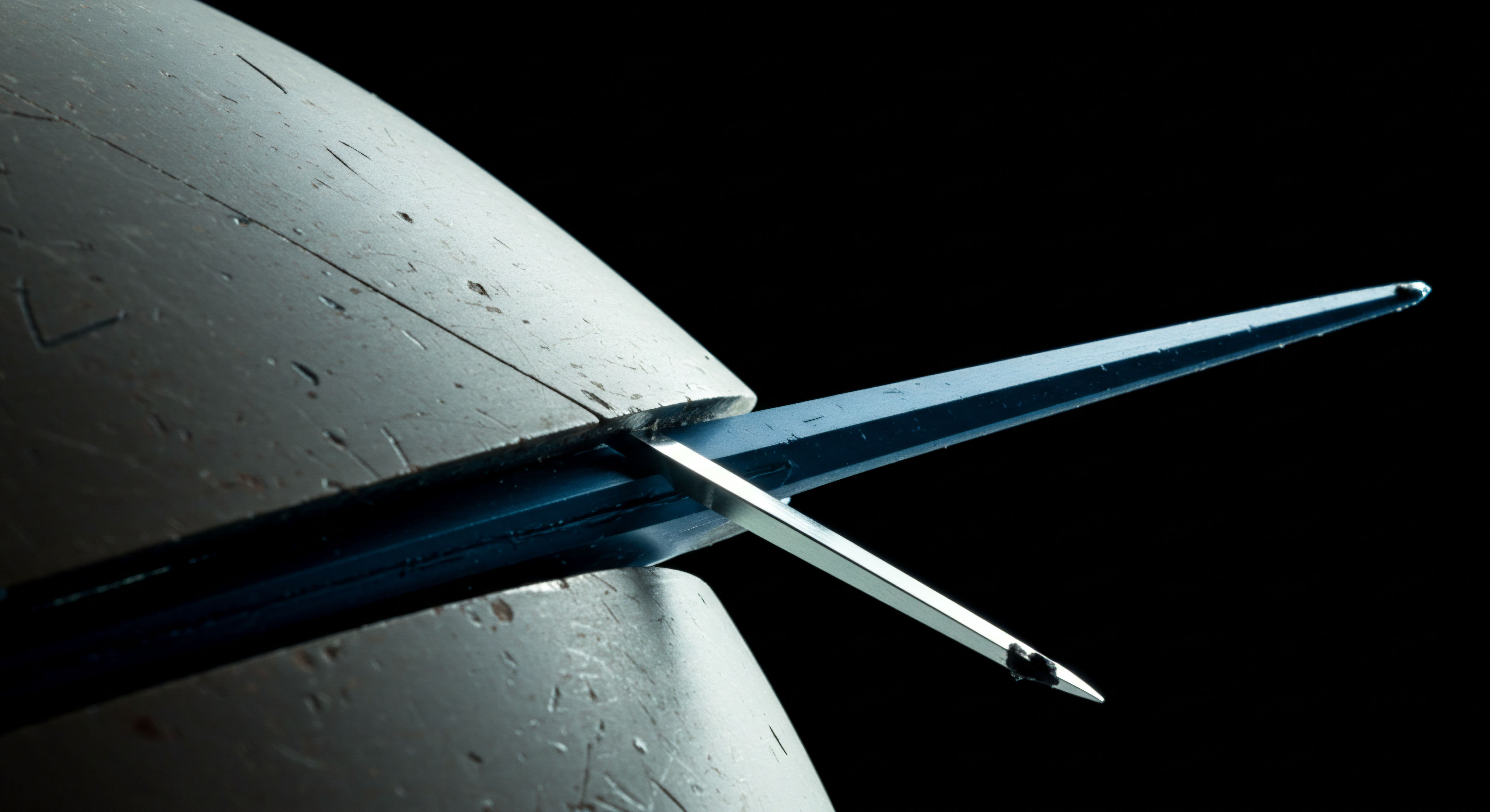 This extreme close-up captures a metallic, sharply pointed instrument bisecting a textured, matte grey substrate, illuminated against absolute blackness suggesting a deep vacuum or conceptual void. The instrument exhibits a precise bifurcated tip, potentially symbolizing the atomic precision required in non-custodial key generation or the delicate mechanism of cross-chain atomic swaps executed via zero-knowledge proofs. The stressed material interface evokes the slippage inherent in high-frequency delta hedging or the forced divergence during market microstructure arbitrage between segregated liquidity pools. Key concepts involve asymmetrical encryption cleavage, settlement finality thresholds, and the structural integrity of secure multi-party computation environments versus the immutable ledger structure. The sharpness represents the precision of oracle data feeding synthetic asset pricing models within decentralized exchange protocols.