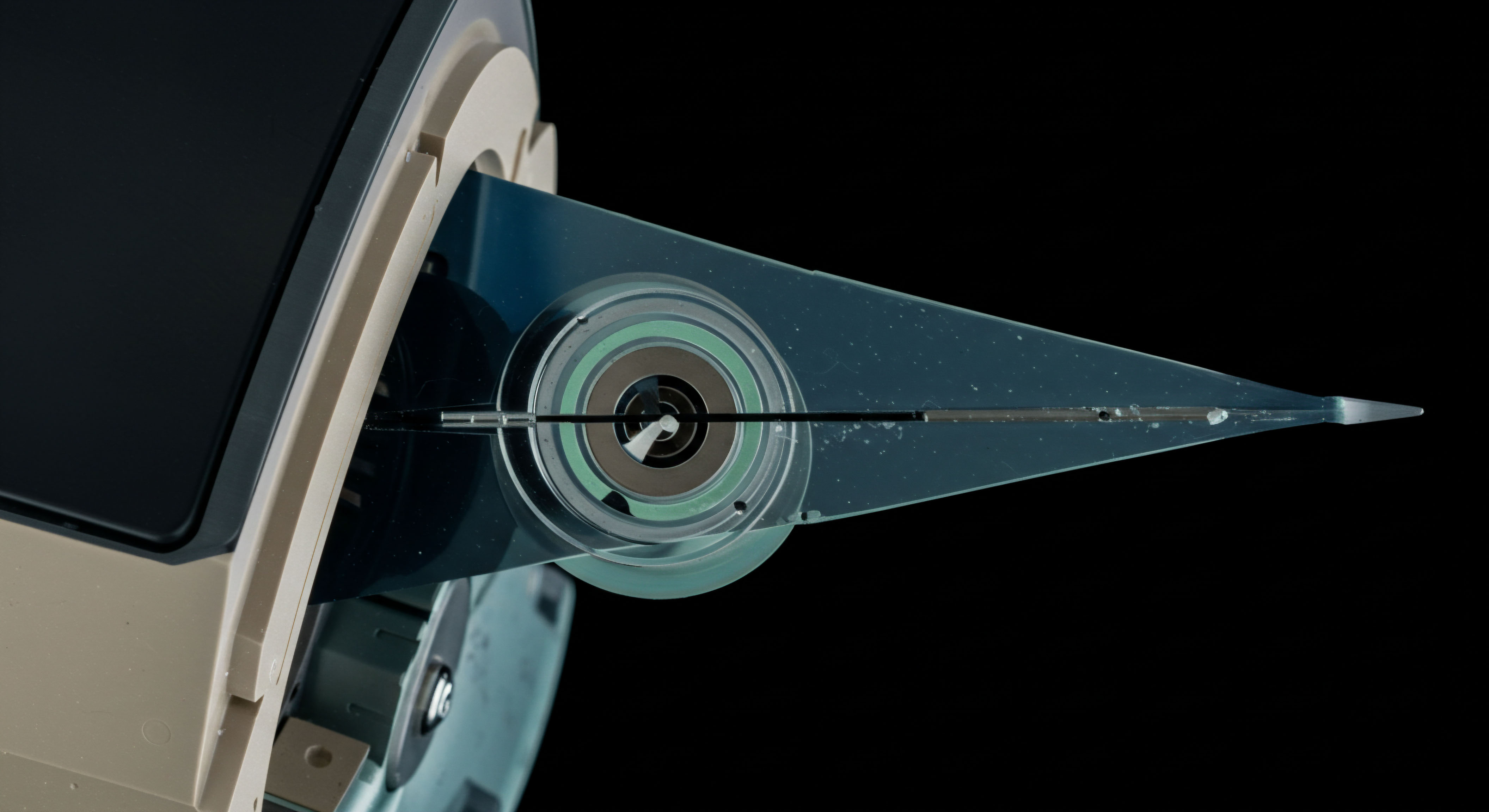 This detailed macro view captures the intricate structure suggestive of an atomic unit within a sophisticated automated market maker mechanism or perhaps a novel settlement layer interface. The translucent, wedge-shaped component housing concentric rings symbolizes the dynamic equilibrium achieved in high-frequency arbitrage across volatile crypto spot markets. A thin, central filament extends toward a sharp terminus, abstractly representing the precision required for executing contingent liquidity provisioning or complex delta hedging strategies on perpetual swaps. The subtle coloration in the radial layers suggests layered collateralization or varying tranche risk profiles inherent in decentralized finance primitive construction, relating directly to capital efficiency in Layer Two scaling solutions and automated option writer functions. This design embodies the pursuit of zero-latency execution underpinning decentralized exchange governance and on-chain derivative settlement protocols safeguarding against slippage erosion.