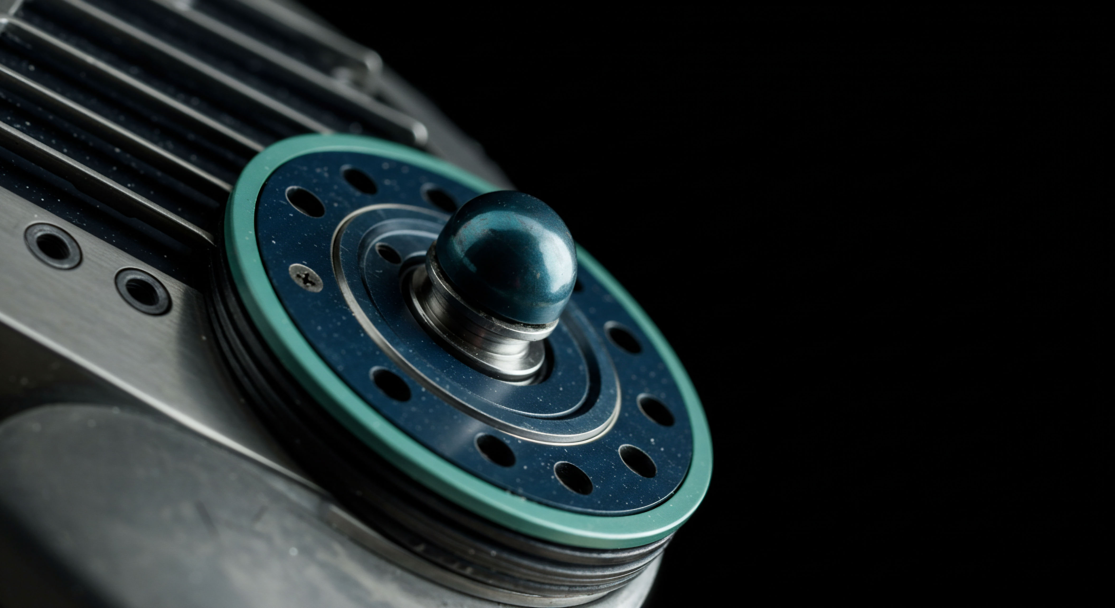 A close up reveals anodized metallic components featuring a central teal sphere nestled within layered dark blue and light green structural rings, set against absolute black negative space. This visual architecture symbolizes the intricate mechanics of high frequency trading protocols governing on-chain settlement. The exposed screw heads and cooling fins suggest robust infrastructure necessary for reliable perpetual swap execution. The central component resembles a control nexus point, reflecting the atomic layer interactions of order flow visualization and volatility surface calibration intrinsic to complex option pricing models on DeFi platforms. This modular construction implies engineered resilience for managing massive liquidity pools and preventing front-running exploits endemic to centralized clearinghouses.