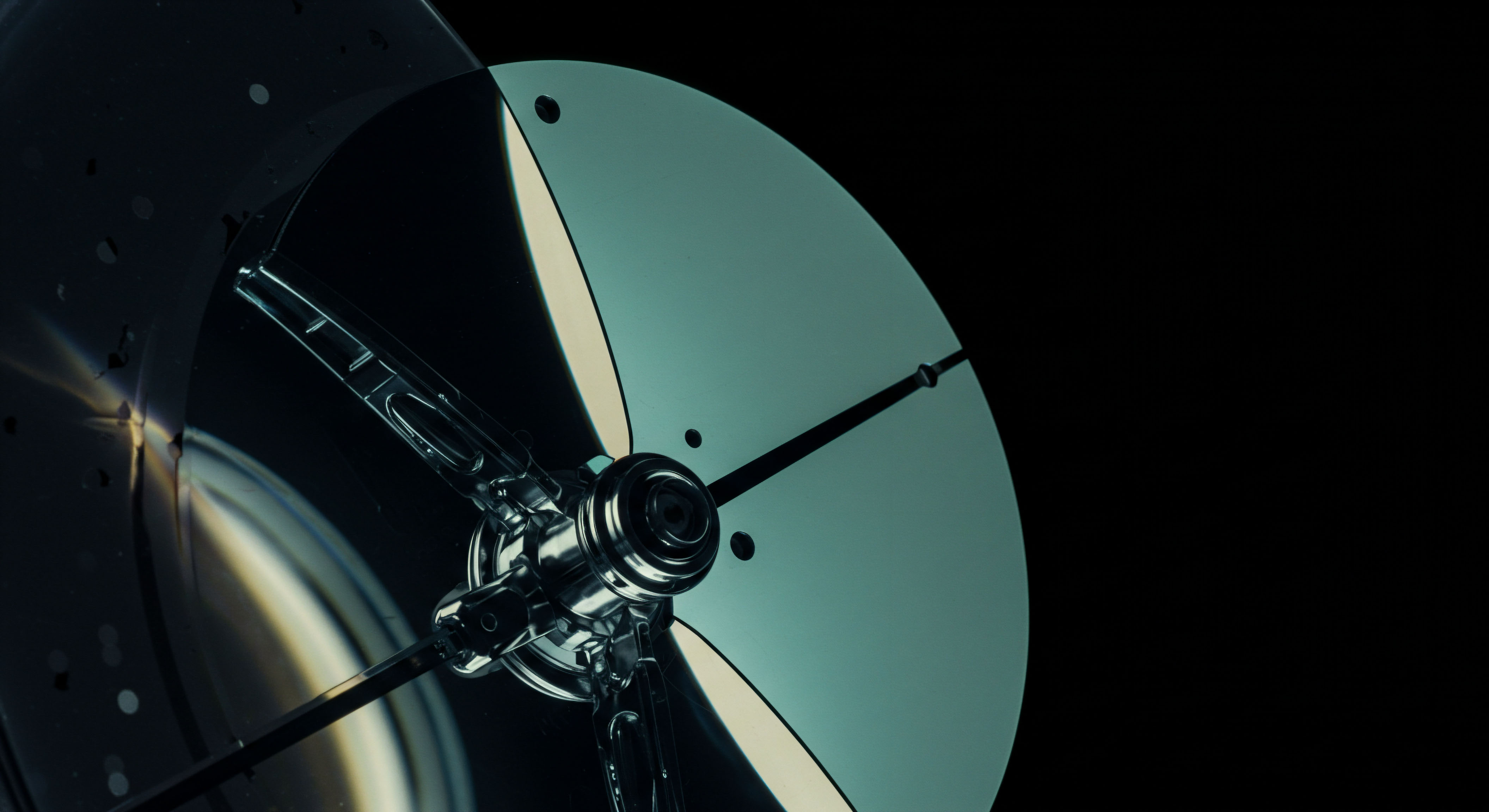 This visual composition depicts highly reflective, segmented metallic surfaces suggesting a precise mechanical apparatus, possibly a finely tuned relay or aperture against absolute black space, mirroring concepts in high-frequency trading microstructure. The central polished hub anchors radial elements, evocative of complex payout structures in exotic options like Barrier or Lookback contracts. The greenish-cyan tint on the largest segment implies materialized volatility skew curves influencing perpetual futures pricing models. This arrangement represents the deterministic precision required for calculating implied volatility surface mapping across various strike prices in decentralized derivative platforms. It symbolizes the transition from raw block data to realized contract value, central to algorithmic arbitrage and effective risk parity management in decentralized autonomous organizations managing synthetic asset liquidity pools.