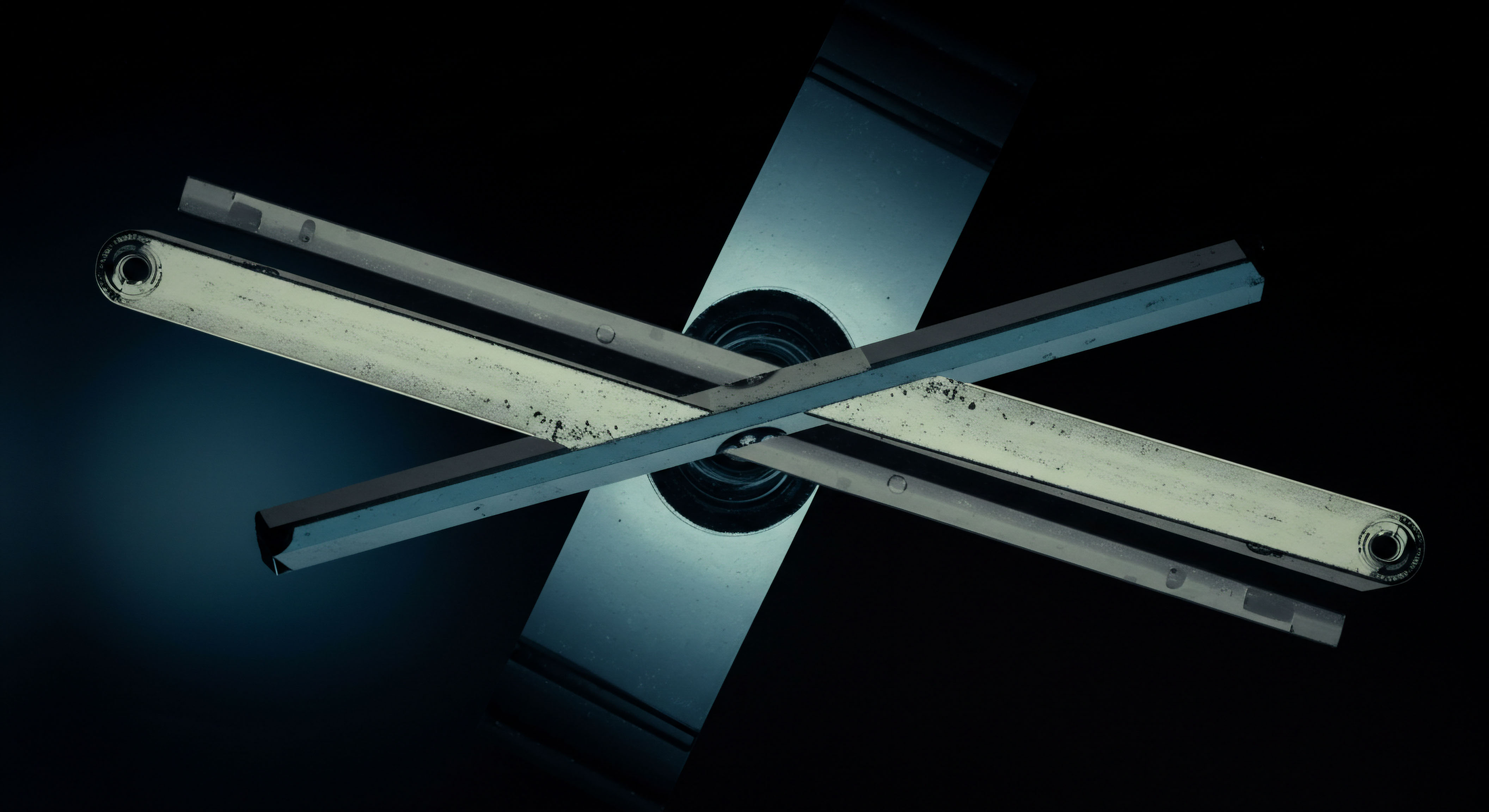 The stark, high-contrast visual presents an intersection of reflective metallic arms against a deep cyan and black void suggesting complex interaction within a dark pool. This structure mirrors the kinetic reality of a margin call mechanism or a complex structured product payoff diagram. The crossed geometry symbolizes the convergence of two distinct asset paths influencing a singular settlement point, akin to an options exchange settled via a collateralized debt obligation structure. Key nomenclature involves the visualization of the Gamma exposure profile intersecting the Theta decay curve at a pivotal strike price, demonstrating implied volatility skews across different maturity tranches. This schematic represents the systemic risk architecture inherent in decentralized finance perpetual swaps execution against centralized exchange liquidity aggregators, requiring precise over-the-counter derivatives calibration for effective delta hedging under turbulent market microstructure.