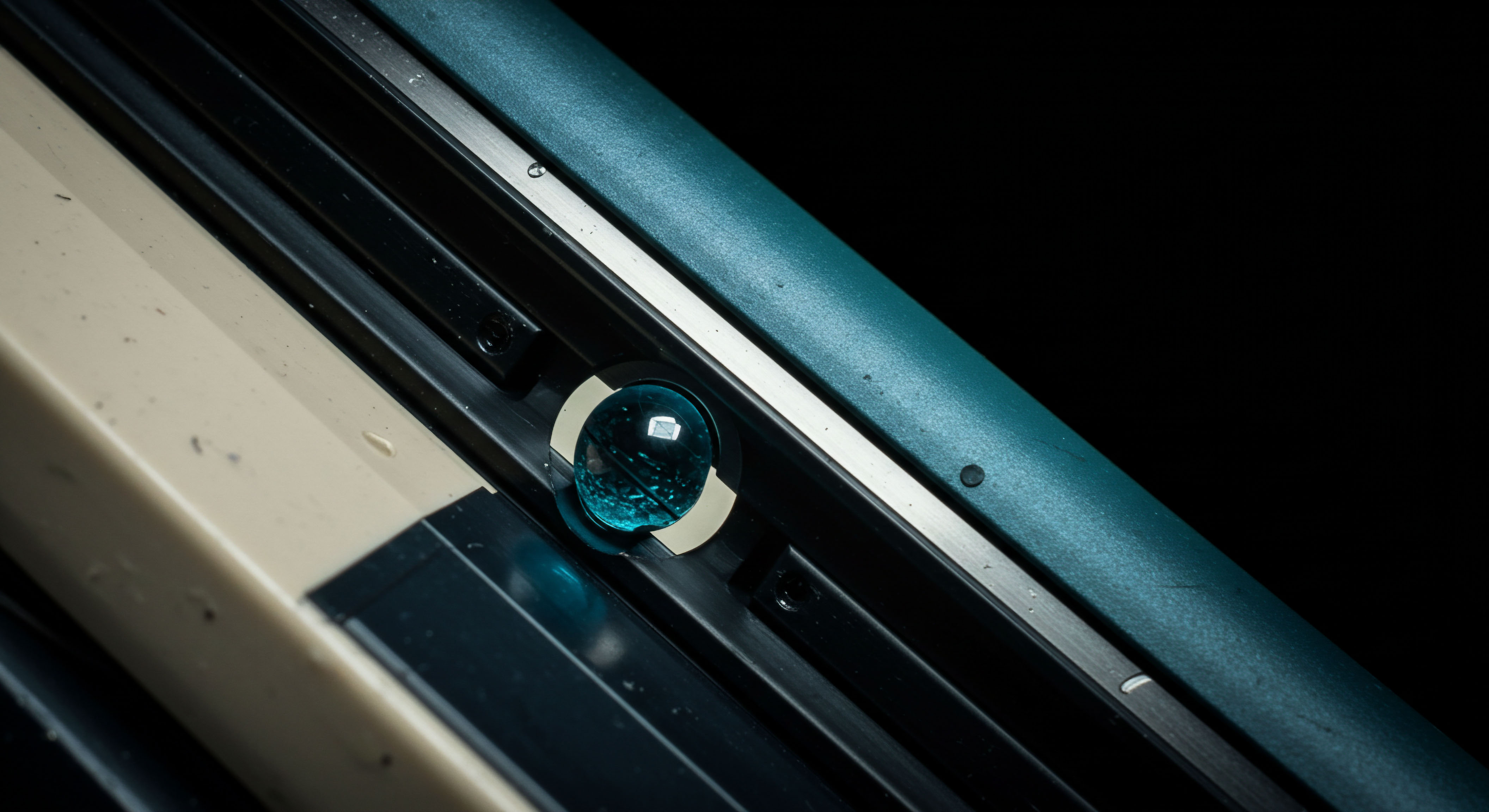 This stark composition illustrates a singular, translucent cerulean orb settled within a machined channel, analogous to latent market volatility captured in a secure ledger system. The contrasting beige substrate and dark structural elements symbolize the secure base layer versus the dynamic trading interface. The sphere represents a trapped premium or an option's intrinsic value, poised at a critical strike price convergence point in decentralized finance derivatives. This visual metaphor speaks to the delicate equilibrium of perpetual futures contracts and the calculated risk associated with embedded option structures, perhaps a reference to minimized slippage within an Automated Market Maker mechanism. Key concepts involve Black-Scholes modeling interpretations, potential realization of delta hedging effectiveness, and the immutable settlement of on-chain collateral pools underpinning complex synthetic assets.