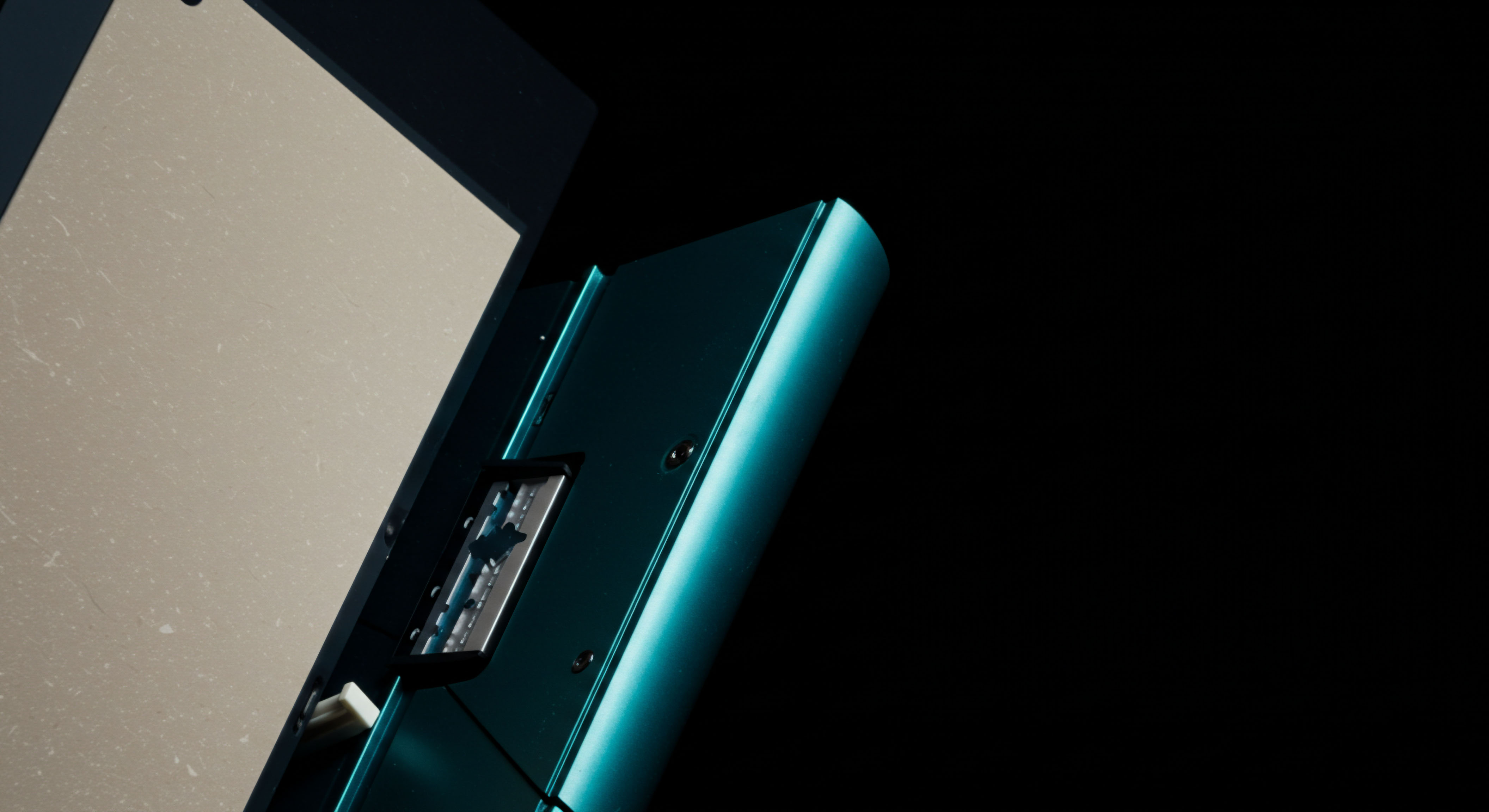 The composition reveals a stark contrast between a luminous, textured beige plane, suggestive of uncollateralized ledger entries or transparent asset revelation, and a densely saturated teal metallic enclosure revealing internal structural components, resembling a hardware security module or cold storage device interface. This visual juxtaposition embodies the inherent duality in decentralized finance derivatives where underlying tokenization risks meet robust cryptographic security protocols. The exposed metallic element suggests a secure enclave for managing private keys or a specialized interface for requesting for quote RFQ interactions regarding complex perpetual swaps or synthetic asset constructs. The deep black negative space accentuates the focused illumination on the asset's housing, emphasizing the insulated nature of digital asset custody against systemic volatility inherent in options market making and structured finance vehicles traversing blockchain rails. Keywords include collateralization ratios synthetic asset replication immutable settlement layer private key ceremony digital asset custody RFQ fulfillment perpetual contract basis trade.